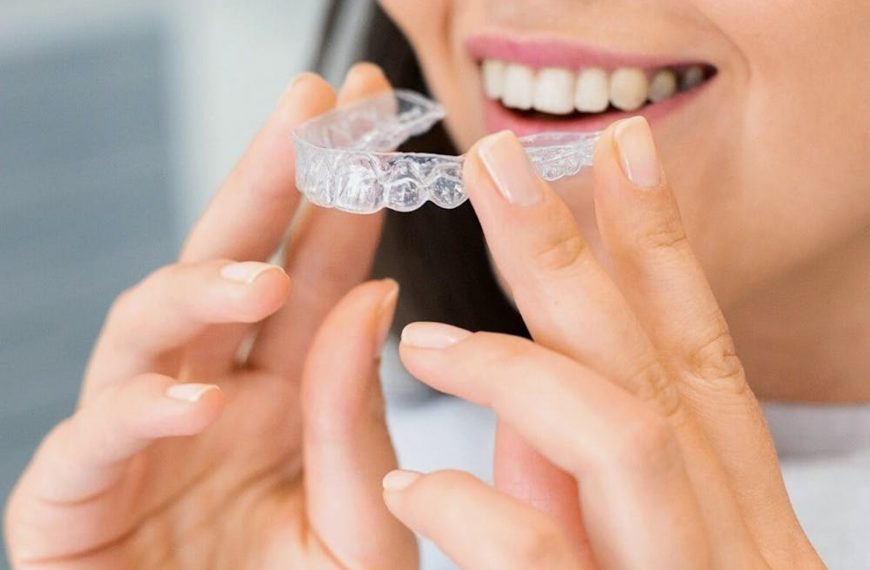 a woman about to wear a clear aligner